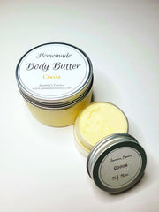 Ivory colored Body butter in 4oz and 1oz containers with a label that reads “Homemade body butter” in cocoa