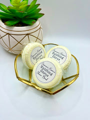 Three yellow Citrus scented shower bombs in a small decorative dish with a label reading: “Jasmine’s Essence Uplifting Citrus Shower Bomb”