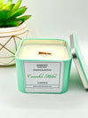 A Cucumber Melon Scented candle with a wooden crackle wick in an 8oz. Light Green square tin with a label that reads: “Jasmine’s Essence Handcrafted Cucumber Melon Candle”