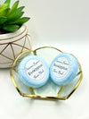 Two blue Eucalyptus scented shower bombs in a small decorative dish with a label reading: “Jasmine’s Essence Eucalyptus Shower Bomb”