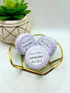 Three purple Lavender scented shower bombs in a small decorative dish with a label reading: “Jasmine’s Essence Lavender Shower Bomb”